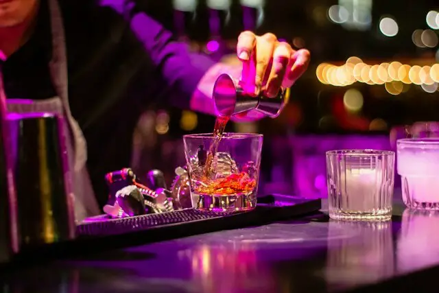 A bartender make a whiskey shots